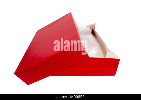 Isolated closed red gift box with tissue paper and lid askew. Stock Photo