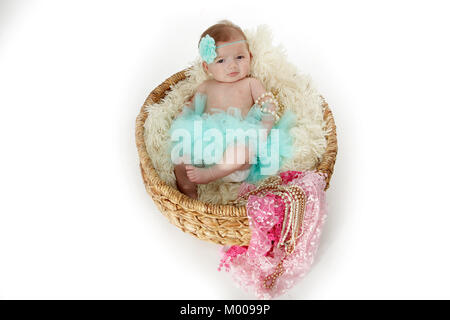 11 week old baby girl in basket with soft blanket Stock Photo