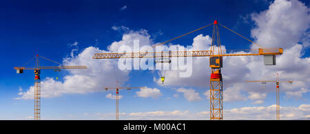 Construction site. Tower cranes on blue cloudy sky background. 3d illustration Stock Photo