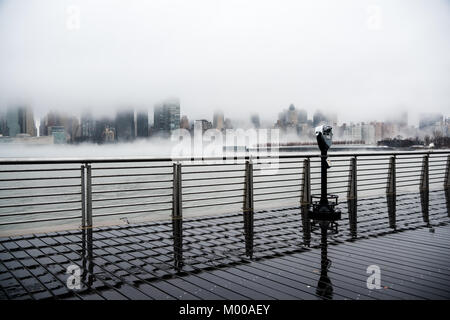 A dense fog covered New York City during the winter's day on January of 2018. View of Manhattan and Roosevelt Island.