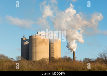 Smoke bellowing out of a chimney at British Sugar factory at Bury St Edmunds, Suffolk, East Anglia, England, UK. Stock Photo