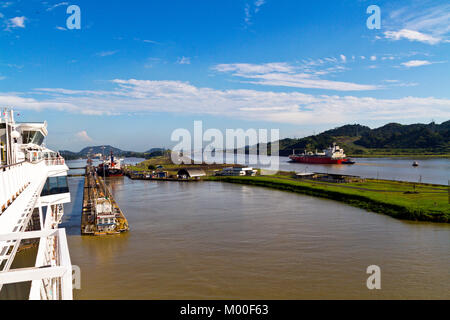 Transiting Panama Canal. Part of a series: Image 6 of 7. Approaching Pedro Miguel locks, prior to Miraflores locks ahead. New locks on the right side. Stock Photo