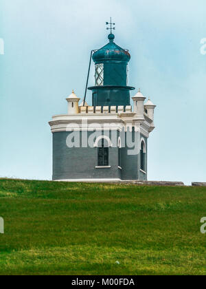 The lighthouse at El Morro fort from the field nearby in Old San Juan. Stock Photo