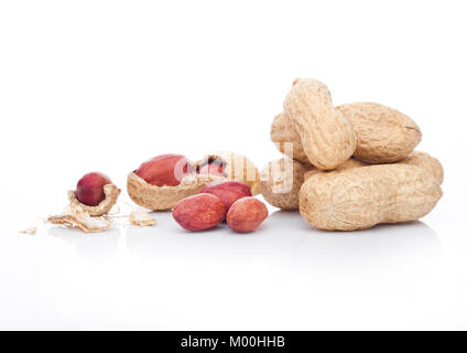 Raw peanuts with shell on white background with reflection Stock Photo