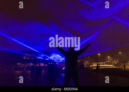 London, UK. 17th Jan 2018. A visitor has fun with the colourful lights of the Waterlicht interactive installation by Daan Roosegaarde, in Granary Square. Lumiere London is a light festival that presents an array of public art work and light installations across the capital. Credit: Imageplotter News and Sports/Alamy Live News