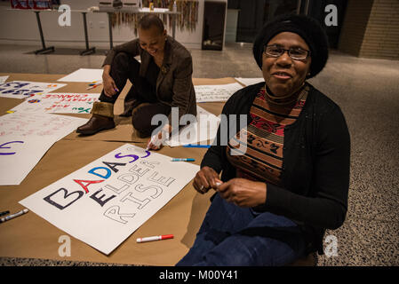 Philadelphia, Pennsylvania, USA. 17th Jan, 2018. Jules Spencer and partner, Jazz Gray-Sadler of West Mount Airy work on a sign together at Taller Puertorriqueño ahead of the Womens March on Philadelphia. Jules and Jazz were photographed at the 2017 march which serves as the banner image for tonight's sign-making event. January 17 2018. Credit: Christopher Evens/Alamy Live News Stock Photo