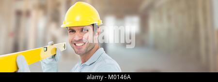 Construction Worker on building site holding spirit level Stock Photo