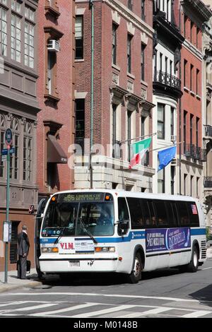 NEW YORK - JULY 2: People board MTA bus on July 2, 2013 in New York. MTA carries over 11 million passengers on a typical weekday systemwide. Stock Photo