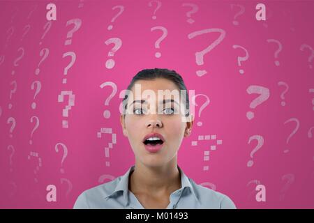 Confused or surprised woman and question marks pattern Stock Photo