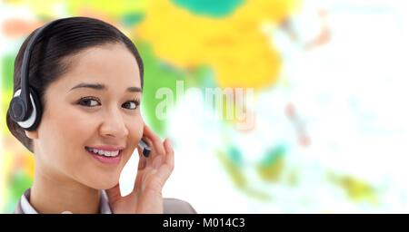 Travel agent woman wearing headset in front of world map Stock Photo