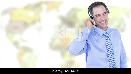 Travel agent man wearing headset in front of world map Stock Photo