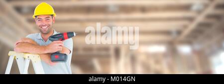 Construction Worker on building site holding drill up ladder Stock Photo