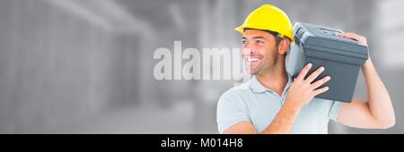 Construction Worker on building site holding toolbox Stock Photo