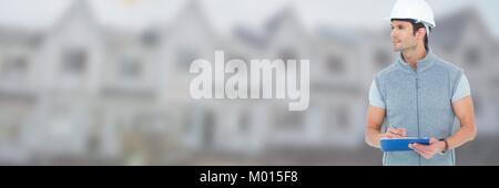 Construction Worker on building site holding chart plans Stock Photo