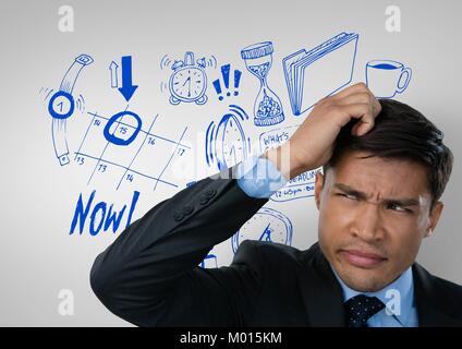 Confused man frowning and scratching his head looking up with drawings Stock Photo