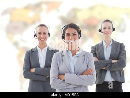 Travel agents wearing headset in front of world map Stock Photo