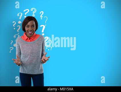 Confused or surprised woman with question marks on blue background Stock Photo