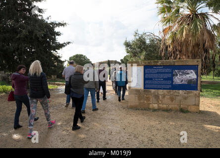 Visitors at the entrance to the Tomb of the Kings archaeological site, Kato Paphos, Paphos, Cyprus. Stock Photo