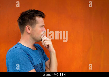 Side view portrait of thinking caucasian young man looking away Stock Photo