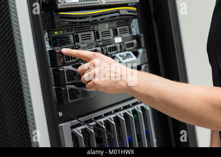 Close-up of IT Engineer Switching On Server At Datacenter Stock Photo