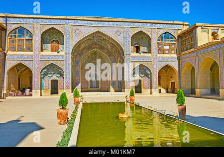 The inner yard of Nasir Ol-Molk mosque, also famous as the Pink Mosque, with the scenic fountain in the middle, Shiraz, Iran. Stock Photo