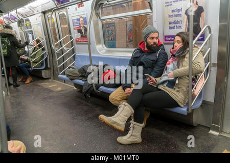 Homeless man takes up several seats as he sleeps in a subway car in New ...