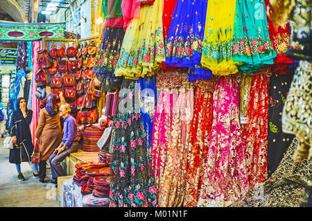 SHIRAZ, IRAN - OCTOBER 12, 2017: The showcase of the textile store in Vakil Bazaar with bright colored synthetic materials (organza, etc), decorated w Stock Photo