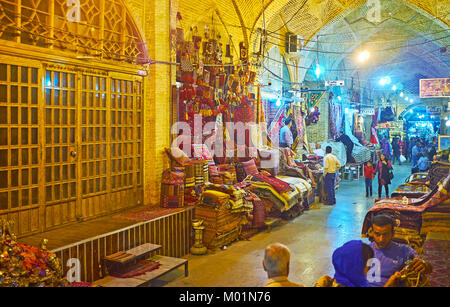 SHIRAZ, IRAN - OCTOBER 12, 2017: The carpet department of Vakil Bazaar is one of the most popular tourist locations, here visitors enjoy the beauty of Stock Photo