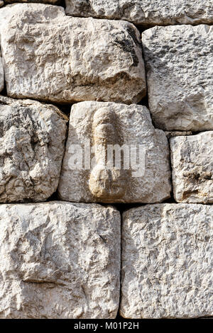 Phallic Symbol carved into the stone wall at the entrance to the Roman city of Empuries, Costa Brava, to warn off unwanted visitors Stock Photo