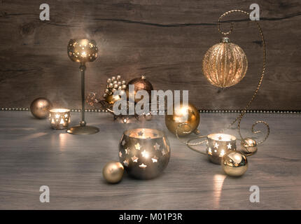 Vintage Christmas decorations, baubles and burning candles on wood. This image is toned. Stock Photo