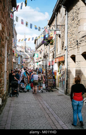 PAIMPOL, FRANCE - JULY 6, 2010: people on shopping street Rue de L'Eglise in Paimpol city in summer. Paimpol is a commune in the Cotes-d'Armor departm Stock Photo