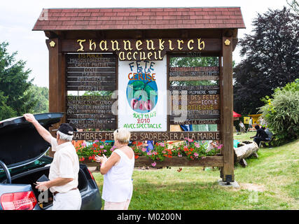 THANNENKIRCH, FRANCE - JULY 11, 2010: tourists near car on traditional fair in Thannenkirch village in summer. Thannenkirch is commune in region of Ba Stock Photo