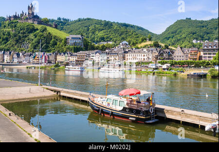 COCHEM, GERMANY - JUNE 28, 2010: boats in Moselle river near Cochem city with Reichsburg Cochem castle in summer day. Cochem is the biggest town in th Stock Photo