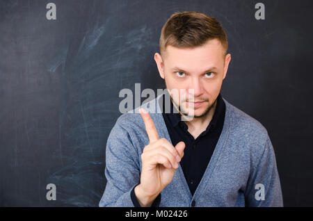 bearded man showing forefinger up direct at camera Stock Photo