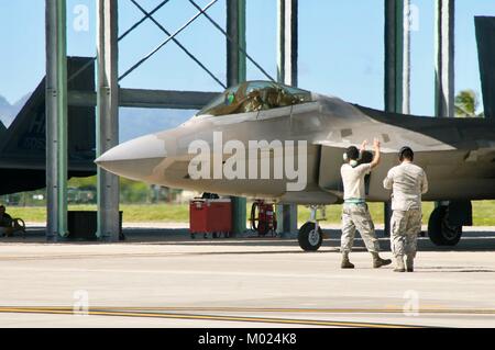 Two crew chiefs with the 154th Maintenance Group, Hawaii Air National Guard prepare to launch a F-22 Raptor at Joint Base Pearl Harbor-Hickam on Jan. 16, 2018 as part of Sentry Aloha exercises. Stock Photo