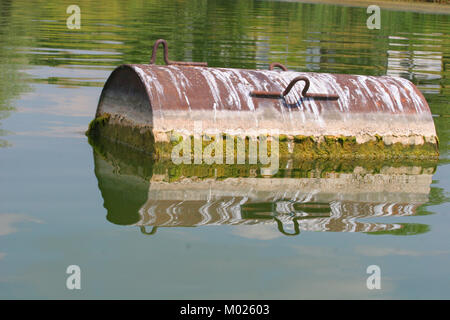 Industrial barrel thrown into the lake for garbage and make a big pollution. Water pollution. Global pollution. Climate changes Stock Photo