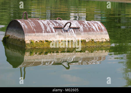 Industrial barrel thrown into the lake for garbage and make a big pollution. Water pollution. Global pollution. Climate changes Stock Photo