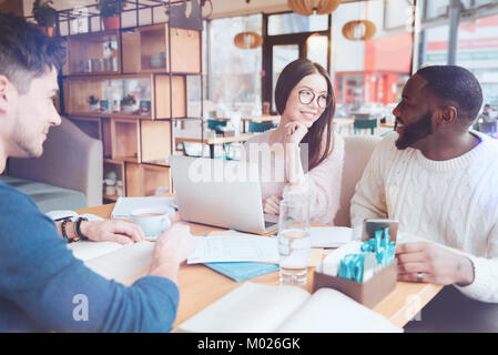 Conversation between friends that being in cafe at the moment Stock Photo