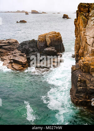 travel in France - view of rocks on coast of Gouffre gulf of English Channel near Plougrescant town of the Cotes-d'Armor department in Brittany in sum Stock Photo