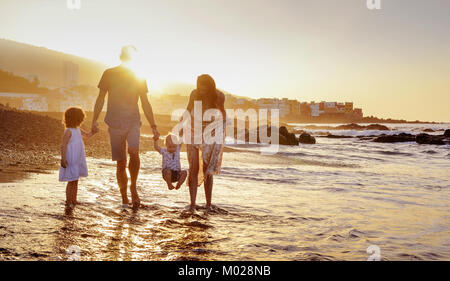 Joyful family having fun on a beach, summer portrait