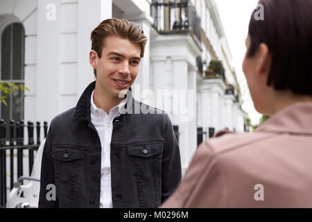 Young couple talking in the street, close up Stock Photo