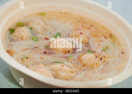 Thai style fish ball noodle soup with chili flakes Stock Photo