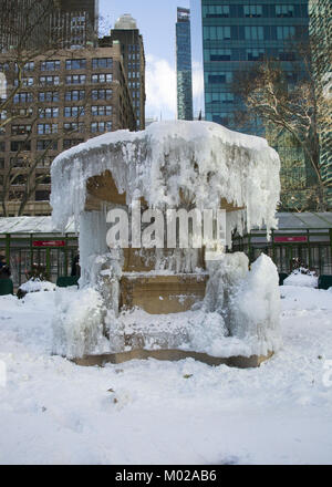 Frozen fountain in Bryant Park in midtown Manhattan during  'deep freeze' weather in New York City. Stock Photo