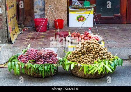 Hanoi,Vietnam - October 31,2017 : Various types of fruits selling from the traditional hanging baskets can found  in Hanoi. Stock Photo