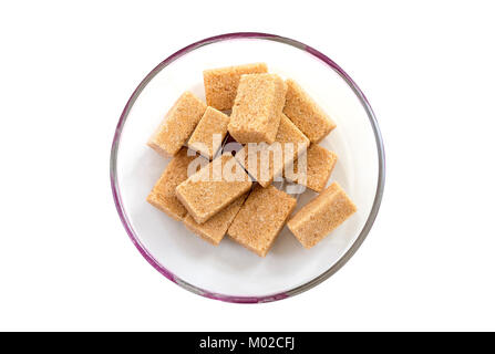 Cubes of whole cane sugar in plate, top view, isolated on the white background Stock Photo