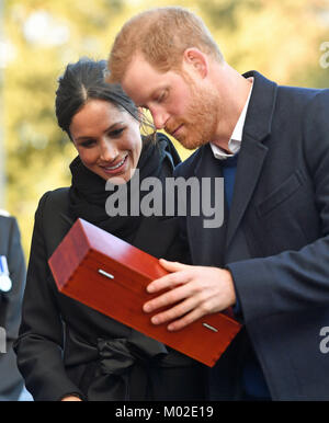 Prince Harry and Meghan Markle who were presented with a gift by Harry Smith and Megan Taylor, both from Marlborough Primary School, during a visit to Cardiff Castle. Stock Photo