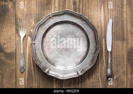Table setting with vintage plate on wooden board. Rustic stile. Romantic dinner. Top view. Stock Photo