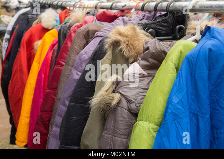 Fashion winter coats hanged on a clothes rack. Stock Photo