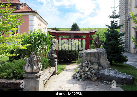 Chinese wooden red arch near Zolochiv Castle in Lviv region, Ukraine Stock Photo