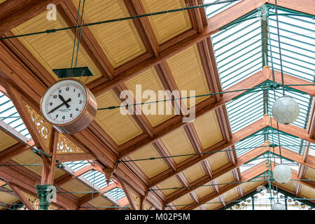 Large brass clock suspended from the roof at Prague Masarykova Station, Prague, Czech Republic Stock Photo